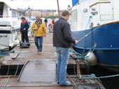 Webmaster Kalle Alpsten (in front) participates in fishing contest under supervision of Gunnar Skold, Malarvarvet Steel Construction